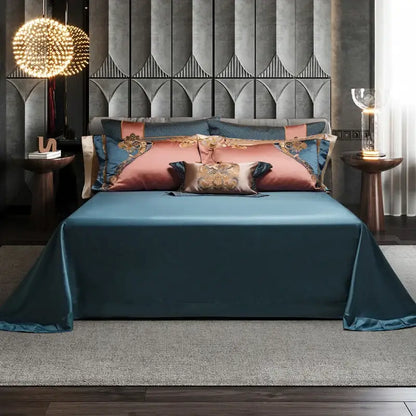 Teal satin bedding set with decorbites luxe gold embroidery featuring dusty rose and gold embroidered pillows