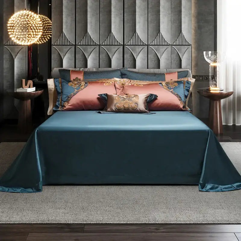 Teal satin bedding set with decorbites luxe gold embroidery featuring dusty rose and gold embroidered pillows