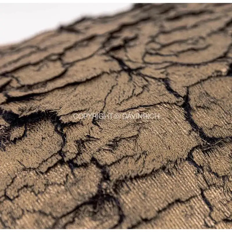 Brown lace fabric cushion cover with cracked tree bark texture and gold foil detail by decorbites luxe gold