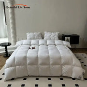White quilted down comforter with plush texture and subtle vertical stitching from decorbites luxe goose collection