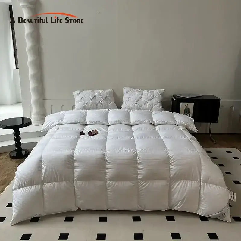 White quilted down comforter with plush texture and subtle vertical stitching from decorbites luxe goose collection