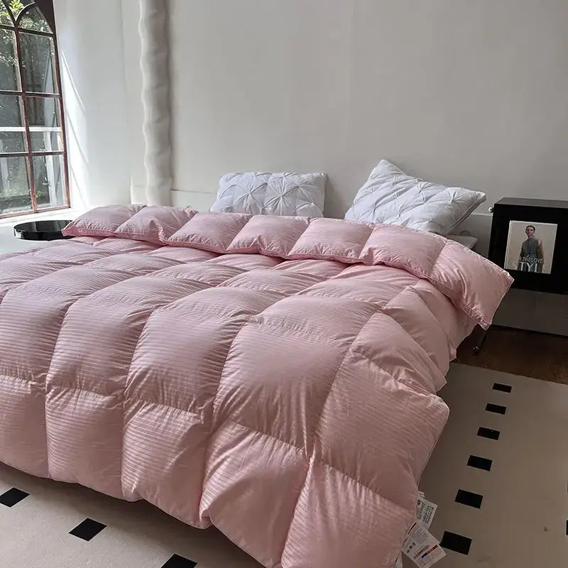 Pink quilted comforter with subtle striped texture featuring decorbites luxe goose down for winter warmth