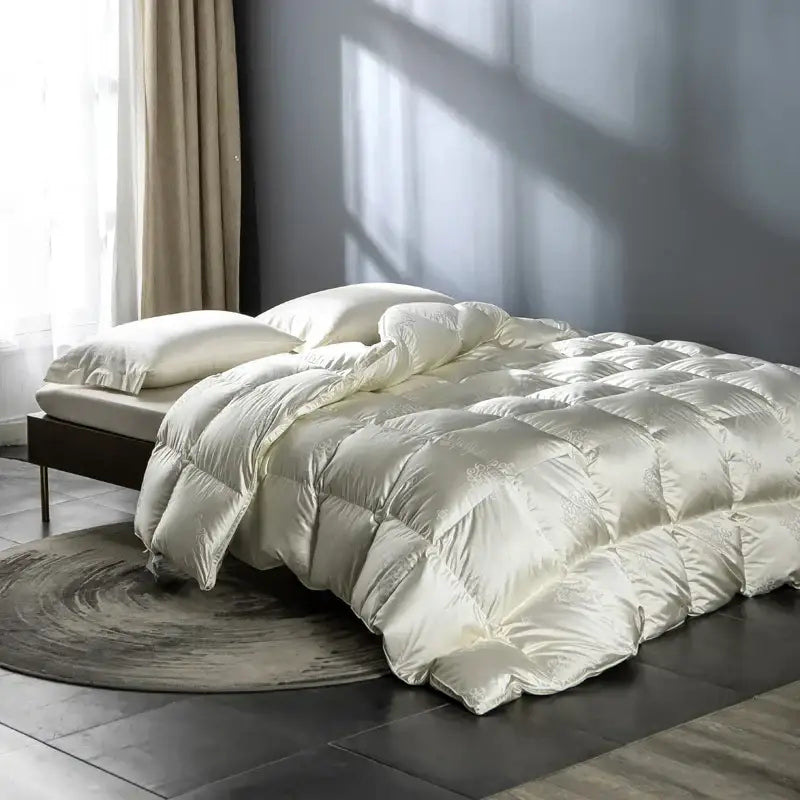 Cream-colored decorbites luxe goose duck down quilt with subtle embroidery and diamond stitching for cozy warmth