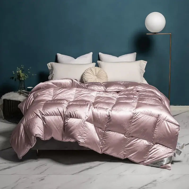 A plush rose-gold satin decorbites luxe goose duck down quilt with quilted design and subtle floral embroidery