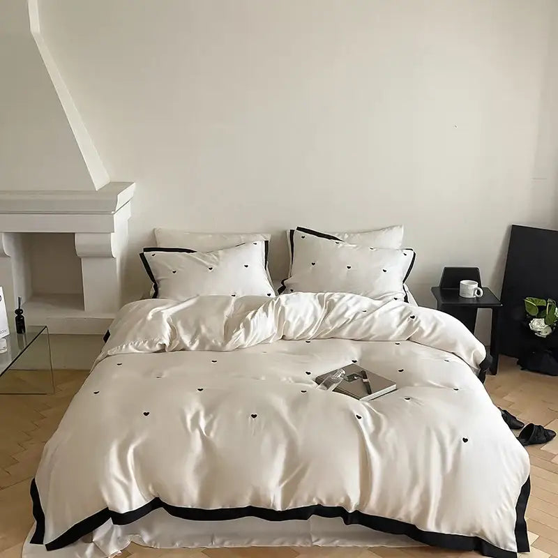 Cream-colored satin bedding set with luxe heart embroidered black hearts and contrasting black trim 100 lyocell duvet cover set