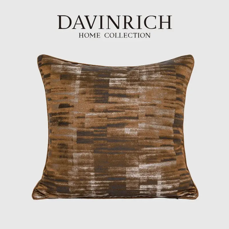 A square plush cushion from decorbites luxe jacquard collection with textured abstract pattern in brown gold coffee tones