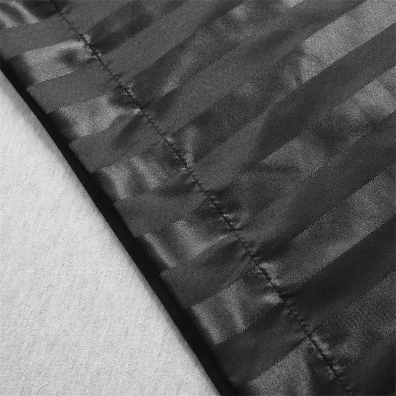 Black satin pillow cover set with subtle vertical jacquard stripes and glossy finish for queen and king size pillows