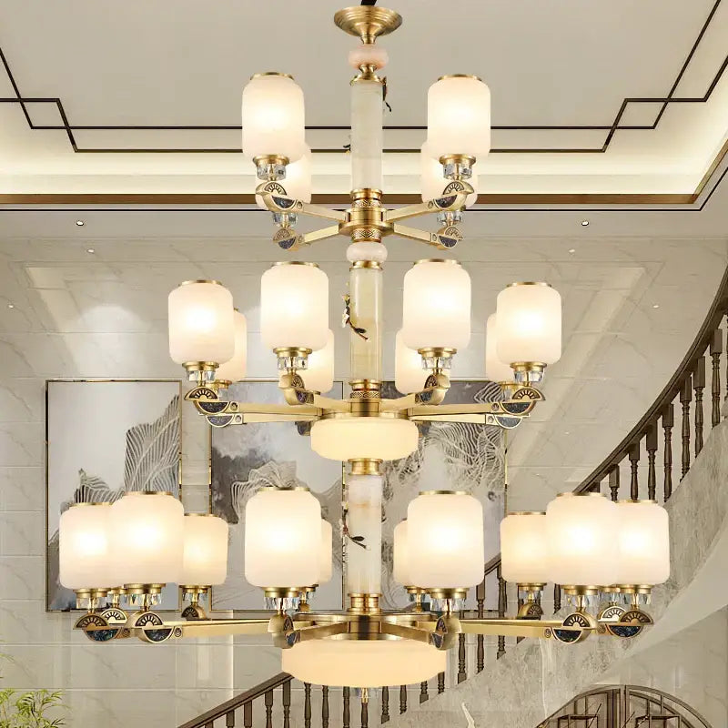 A decorbites luxe jade chandelier with brass arms frosted glass shades and a white marble column for living rooms