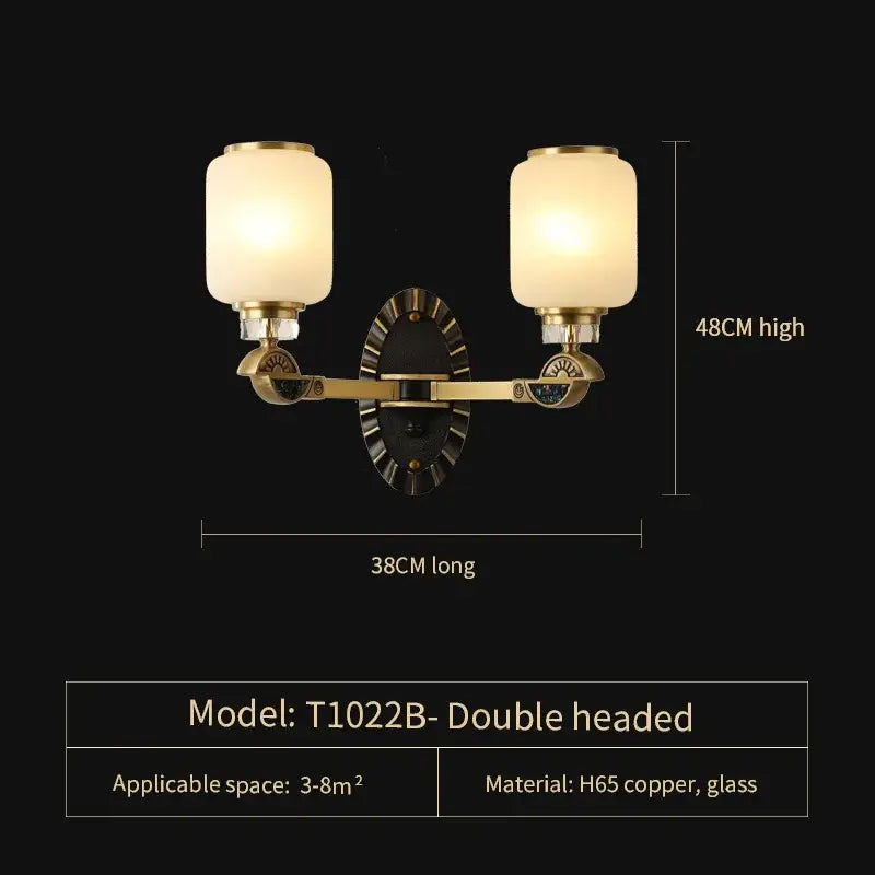 Brass double-headed wall sconce with frosted glass shades and circular backplate from decorbites luxe jade chandelier collection
