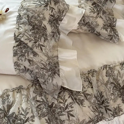 Decorbites luxe lace bedding set with sheer gray botanical print fabric and white satin luxe lace ruffles for weddings