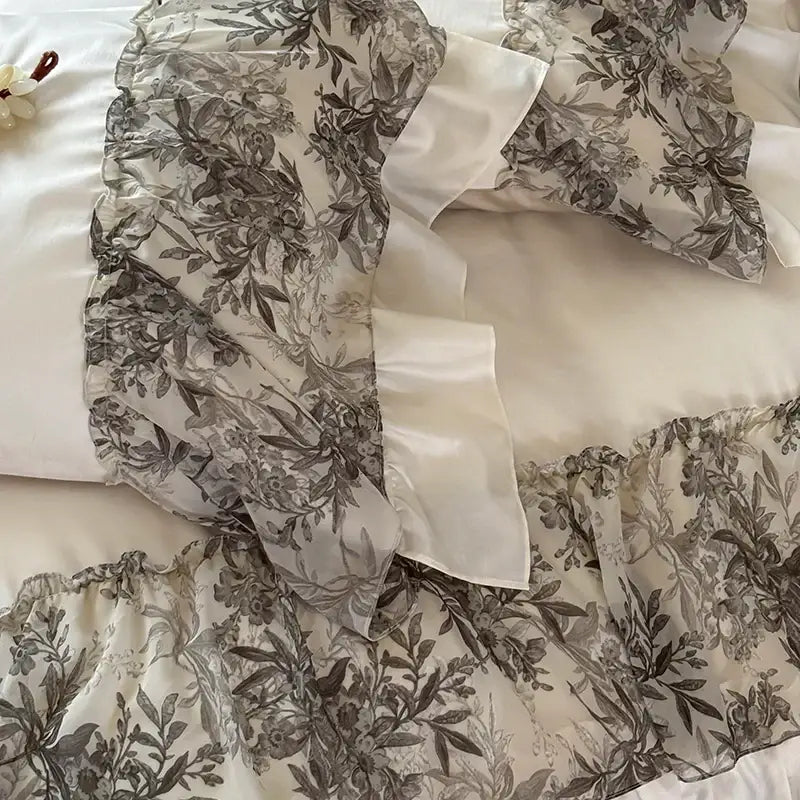 Decorbites luxe lace bedding set with sheer gray botanical print fabric and white satin luxe lace ruffles for weddings