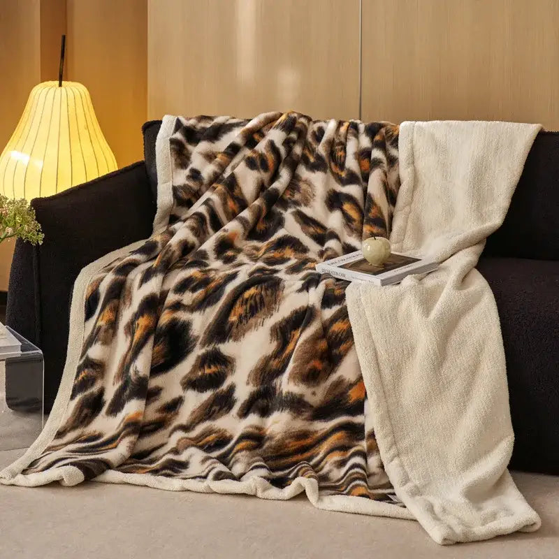 A plush decorbites luxe leopard throw blanket with cream fleece lining for cozy office and sofa use