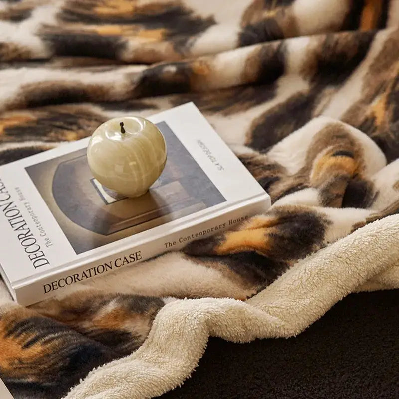 Cream-colored plush faux fur throw blanket with bold leopard print in brown black and cream by decorbites luxe leopard