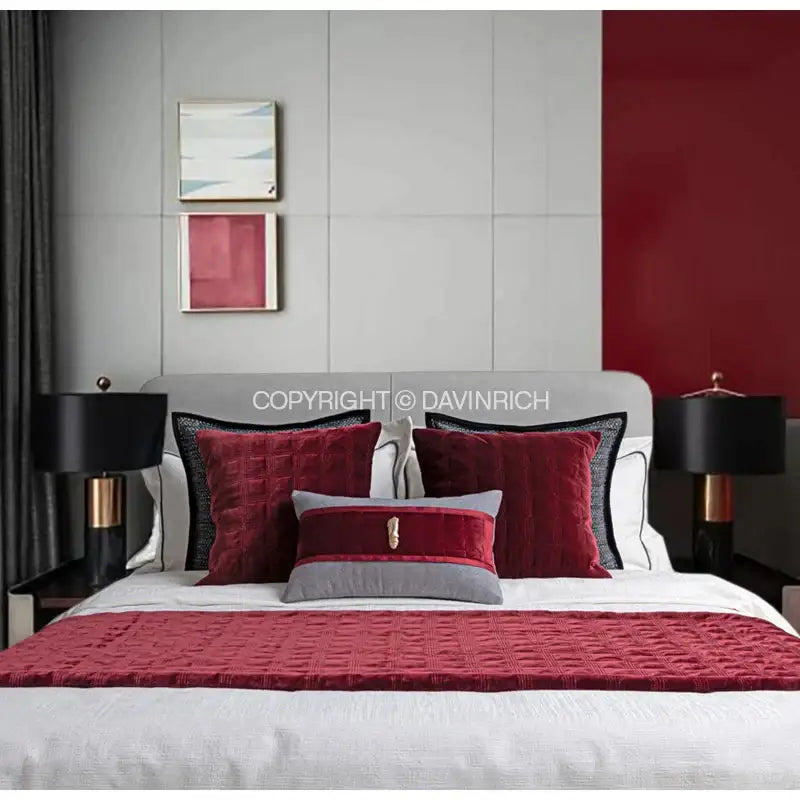 Red quilted velvet throw blanket with subtle texture layered over white bedding complements decorbites luxe linen cushion covers