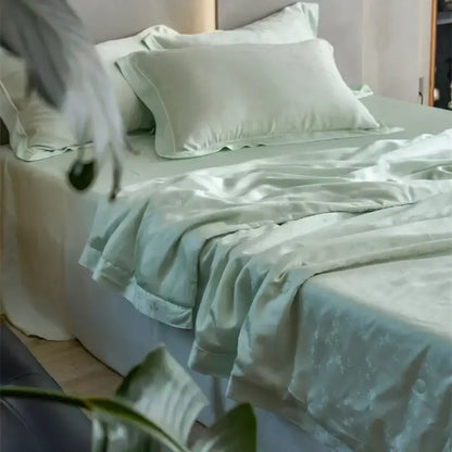 A soft mint-green satin summer blanket with mulberry silk fill in the decorbites luxe lyocell jacquard comforter set