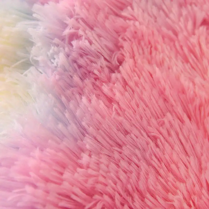 A plush decorbites luxe mink fleece patchwork quilt with a soft pink gradient and pastel white and yellow hues
