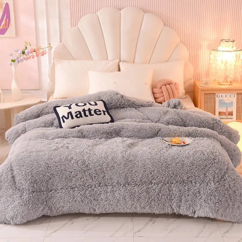 A plush gray faux fur throw blanket with soft fluffy texture and cozy oversized drape from decorbites luxe mink fleece collection