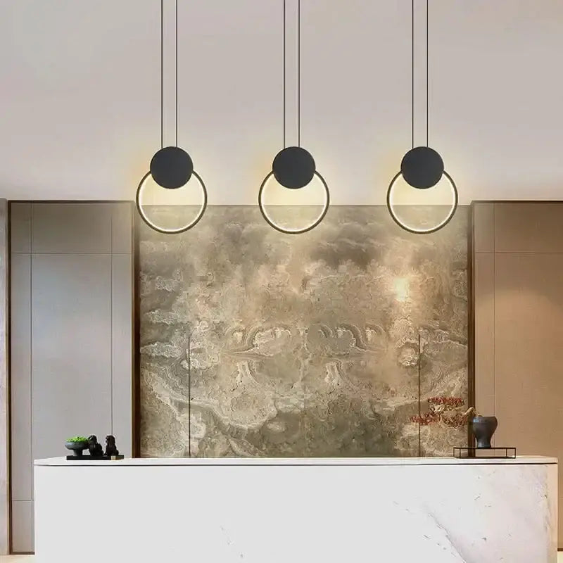 Three black pendant lights with gold accents from decorbites™ luxe nordic circle lamp for home decor and ambiance
