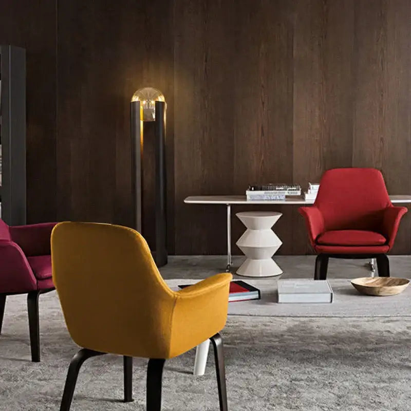 Vibrant mustard-yellow upholstered armchair with sleek black metal legs beside decorbites luxe nordic led floor lamp