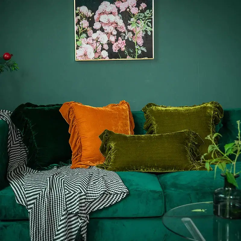 Emerald green velvet sofa with DecorBites™ luxe orange velvet ruffled euro pillow sham for elegant decor