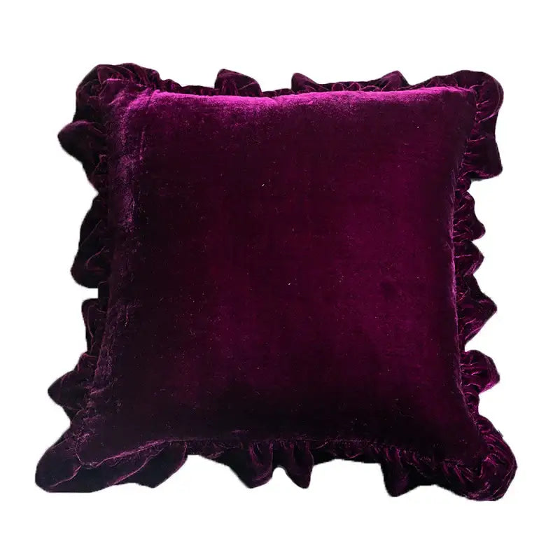 A plush deep purple velvet euro pillow sham with decorative ruffled edge showcasing french style elegance