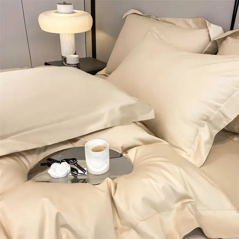 Cream-colored satin duvet cover and fitted sheet set with smooth texture and elegant pleated pillowcases from decorbites