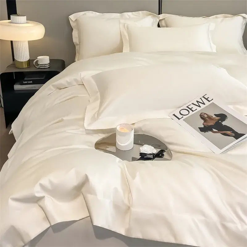 Cream-colored satin duvet cover and fitted sheet set with smooth texture and elegant pleated edges by DecorBites™
