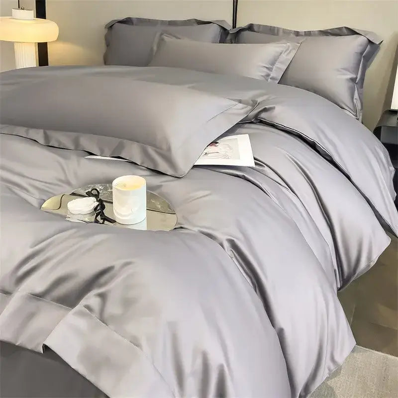 Silk-gray satin duvet cover set with matching pillowcases and fitted sheet featuring pleated edges in egyptian cotton