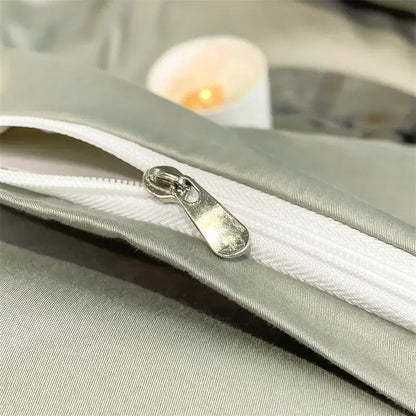 Silver-toned zipper pull on light gray satin fabric of DecorBites™ luxurious 1000TC Egyptian cotton duvet cover