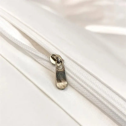 Silver-toned zipper pull on white fabric zippered seam of decorbites™ luxurious 1000tc egyptian cotton duvet cover