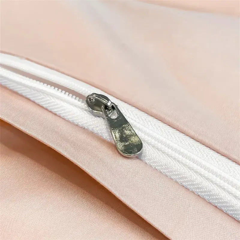 A silver-toned zipper pull with matte finish on a white zipper track of decorbites™ luxurious 1000tc cotton duvet cover