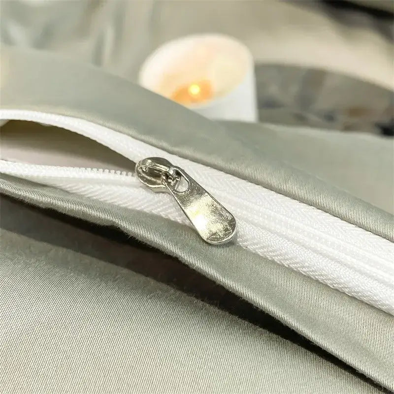 Silver-toned zipper pull on light gray satin fabric of decorbites luxurious 1000tc egyptian cotton duvet cover