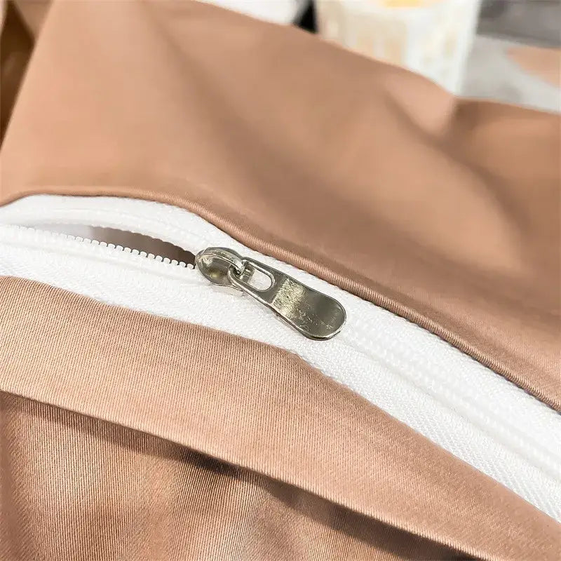 A sleek silver zipper on taupe 1000tc egyptian cotton fitted sheet from decorbites luxurious bedding set