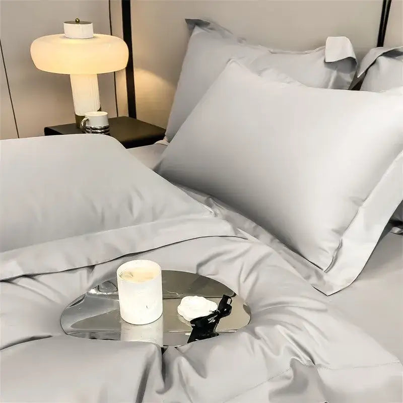 A sleek metallic tray with reflective surface holding a candle complements decorbites luxurious 1000tc duvet cover set