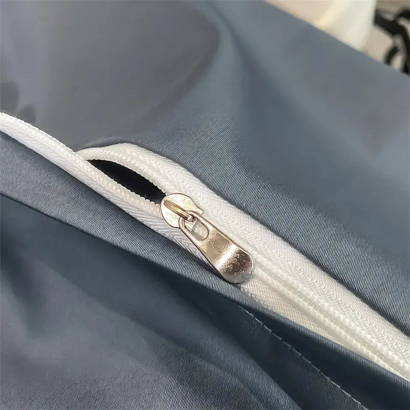 A sleek silver zipper on the dark gray seam of DecorBites™ luxurious 1000TC Egyptian cotton duvet cover