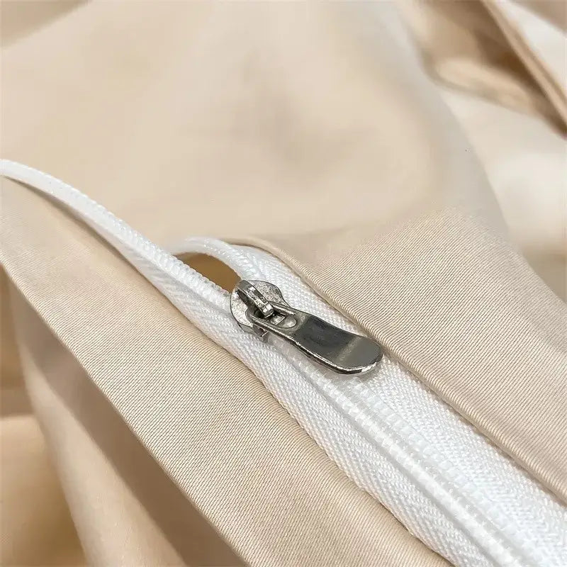 A sleek silver zipper with a metallic pull tab on the beige piece duvet cover of decorbites™ 1000tc egyptian cotton bedding set