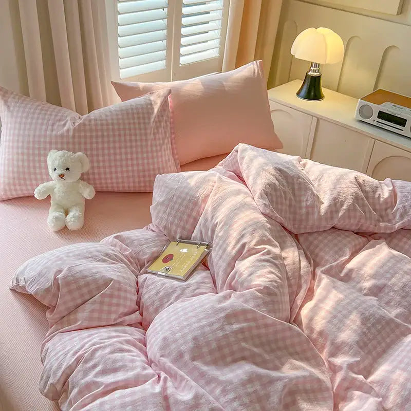 Pink gingham cotton duvet cover with matching pillows and plush white teddy bear in decorbites luxurious bedding set