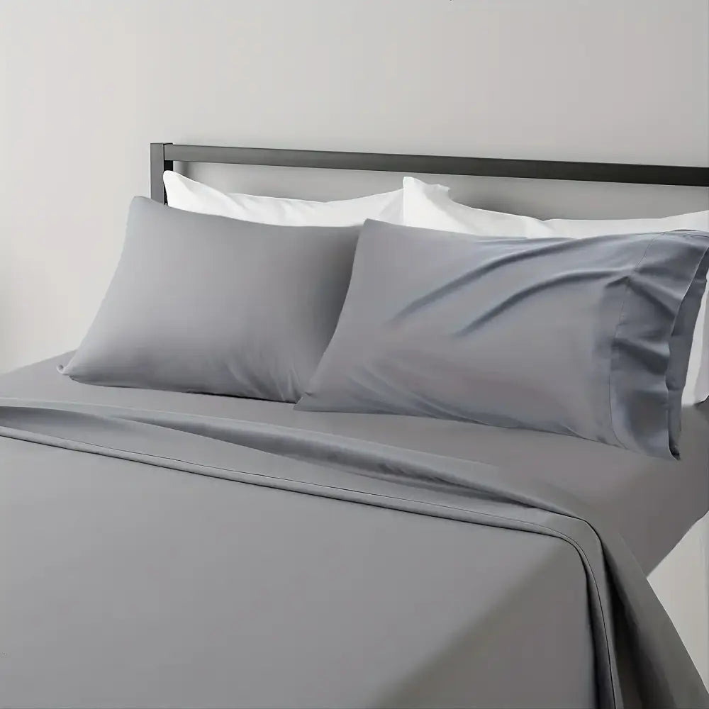 Gray satin pillowcases with a smooth glossy finish from the DecorBites™ luxurious cooling sheet set for soft breathable comfort
