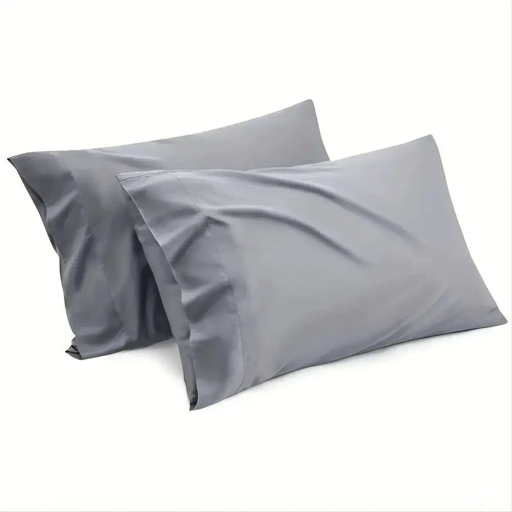 Two matching gray pillowcases from decorbites™ luxurious cooling sheet set with smooth, slightly shiny fabric finish