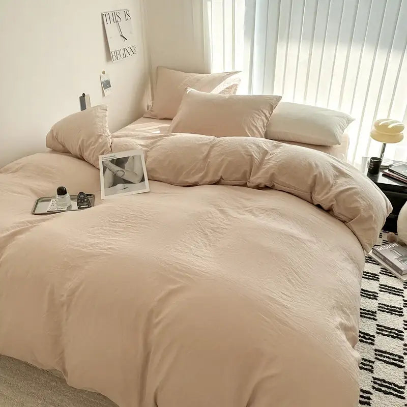 Beige soft-textured decorbites™ luxurious cotton bedding set with matching pillows arranged neatly on a bed