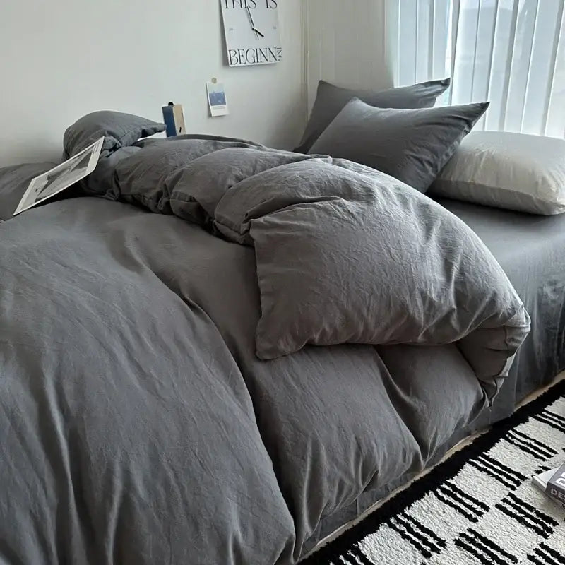 Gray textured cotton bedding set with matching pillows featuring a slightly rumpled duvet cover from decorbites™ luxury collection