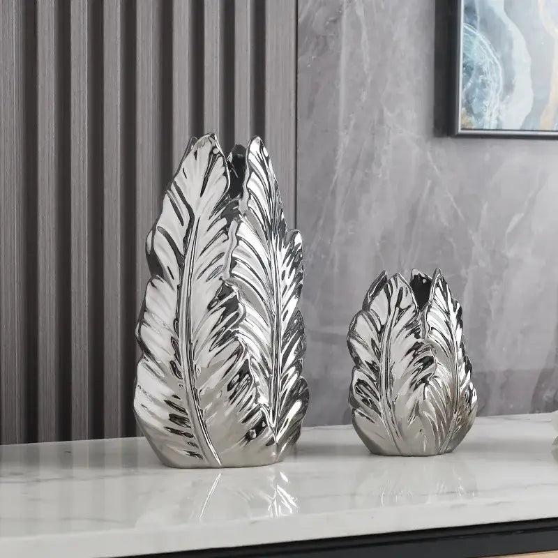 Shiny silver ceramic leaf-shaped vases with detailed veining and glossy finish for luxurious gold ceramic home decor