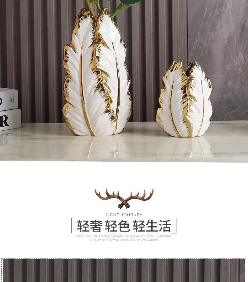White ceramic gold ceramic vases with gold leaf detailing shaped like stylized feathers for home decor