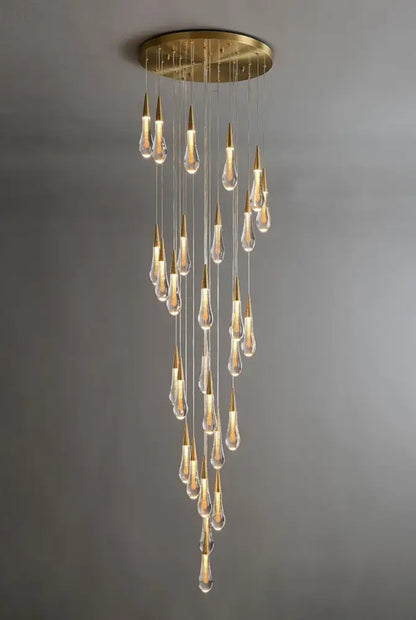 DecorBites™ luxurious gold crystal chandelier with circular brass base and cascading teardrop pendants for staircase lighting