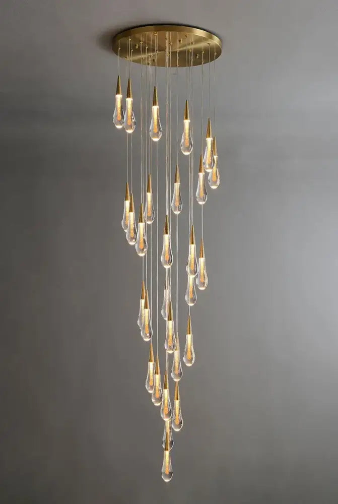 DecorBites™ luxurious gold crystal chandelier with circular brass base and cascading teardrop pendants for staircase lighting