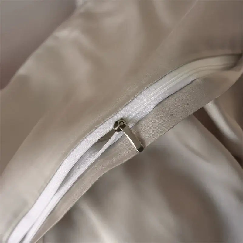 Beige satin pillowcase with white zipper and silver pull tab from decorbites™ luxurious lyocell silk bedding set for duvet cover and sheets