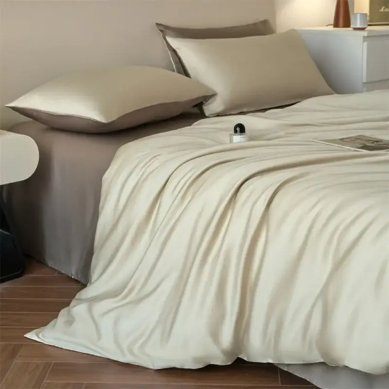Cream-colored satin duvet cover with smooth glossy finish from DecorBites™ luxurious lyocell silk bedding set queen king size