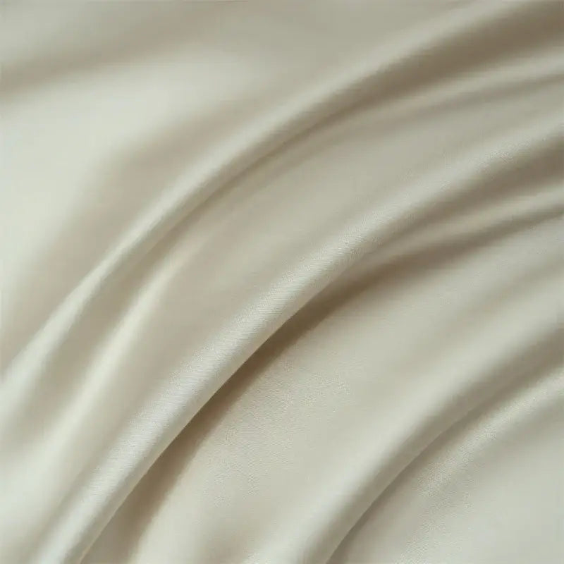Cream-colored satin duvet cover with smooth glossy finish and gentle folds in decorbites luxurious lyocell silk bedding set
