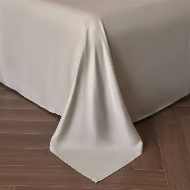Cream-colored satin duvet cover from decorbites™ luxurious lyocell silk bedding set with smooth flowing drape
