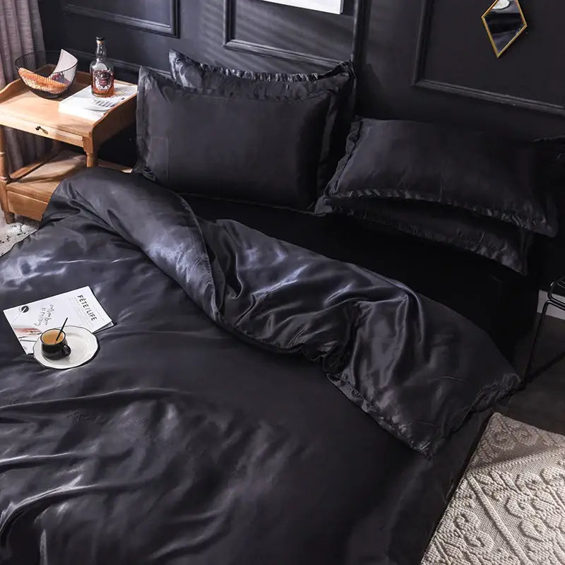 Black satin silk bedding set from DecorBites™ featuring a glossy smooth texture and elegant ruffled edges